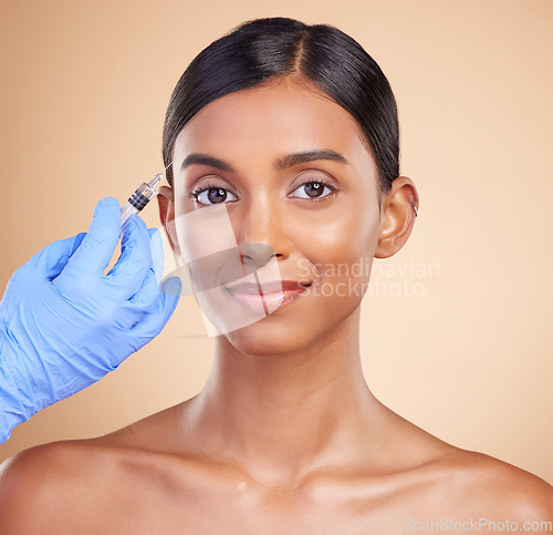 Image of Portrait, smile or Indian woman with injection for plastic surgery, beauty or medical cosmetics in studio. Skincare, dermatology or hand with needle for face lift or facial treatment on happy girl