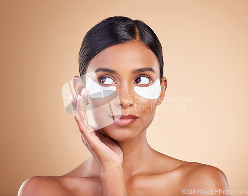 Image of Face, skincare or Indian woman with eye patch for beauty isolated on studio background. Cosmetics or girl model with facial collagen pads or dermatology product for anti aging, hydration or wellness