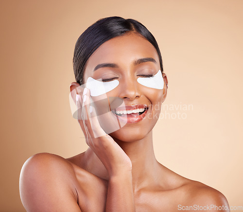 Image of Face, skincare or happy woman with eye patch for beauty or wellness isolated on studio background. Cosmetics or girl model with facial collagen pads or dermatology product for anti aging or hydration