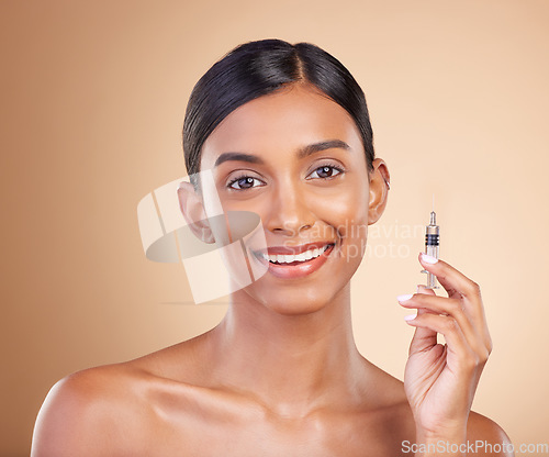 Image of Face, skincare and woman with botox injection in studio isolated on a brown background. Portrait, dermatology filler and happy Indian model with prp syringe cosmetics for anti aging, beauty or health