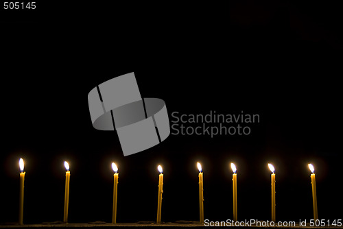 Image of 8 candles in the dark