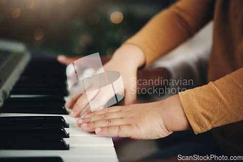 Image of Learning, piano and hands of a child and parent playing a song together. Education, music and zoom of a kid with a dad teaching an instrument during a musical lesson, help and showing to play