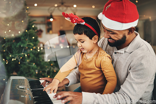 Image of Happy father, child and piano for christmas celebration, songs and xmas hymn at home. Parent, boy kid and teaching keyboard instrument, festive music and celebrate fun holiday spirit with audio sound