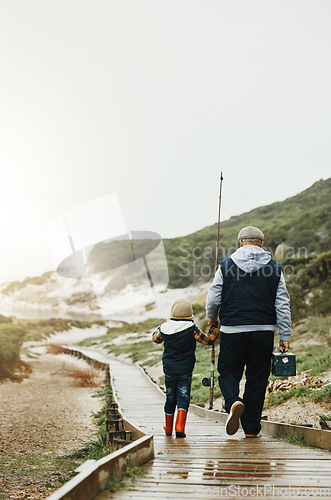 Image of Walking, fishing and grandfather with child outdoor for lesson, leisure activity or hobby. Travel, bonding and back of senior man with kid to teach him to catch fish while on vacation or weekend trip