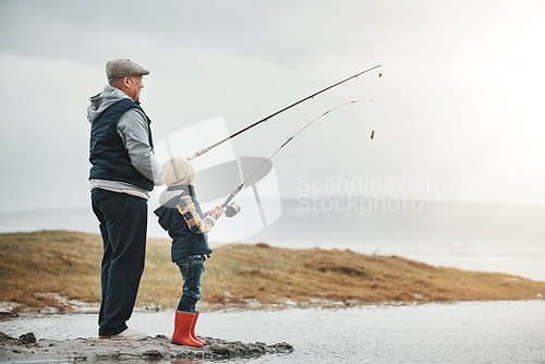 Image of Lake, travel and grandfather fishing with a kid while on a adventure, holiday or weekend trip. Hobby, outdoor and elderly man teaching a child to catch fish in nature while on vacation in countryside