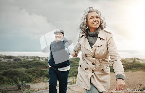 Image of Beach, love and senior couple holding hands on romantic evening walk in nature on happy date. Smile, romance and retirement, old woman and man walking on ocean path at sunset on holiday in Australia.