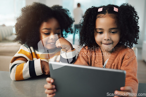 Image of Sisters, children and girls smile with tablet in home, playing games and bonding together. Technology, family and happy mixed race kids with touchscreen for elearning, streaming movie or web browsing