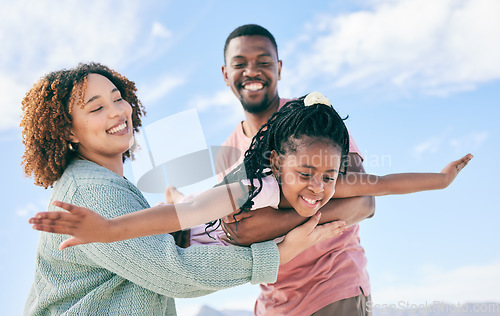 Image of Happy family, fly or girl with parents at beach on summer holiday vacation or weekend together. African dad, funny mother or excited child love bonding, laughing or relaxing while playing in nature