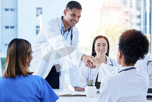 Image of Handshake, doctors and medical meeting in agreement, collaboration and smile of teamwork, welcome or deal. Happy healthcare employees shaking hands in hospital partnership, greeting or clinic success