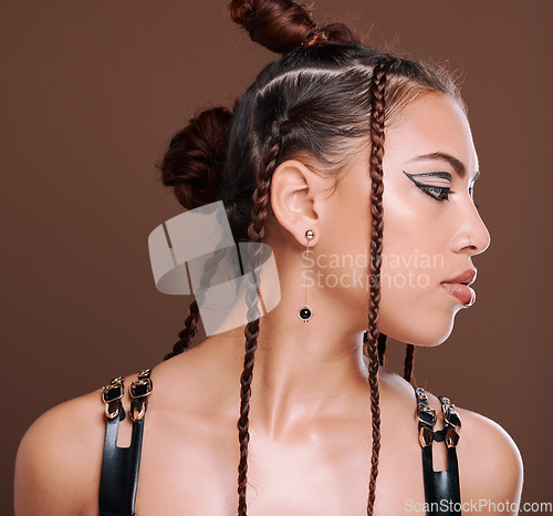 Image of Rock, fashion and woman with makeup for beauty and style isolated in a studio brown background. Unique, hairstyle and creative punk cosmetics or aesthetic and gen z female model in hipster clothes