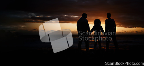 Image of Beach, sunset and silhouette of a family holding hands in the dark while on summer vacation or trip. Adventure, love and shadow of people in nature by ocean together while on seaside travel holiday.