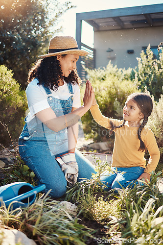 Image of Family, children or high five with a mother and daughter gardening while planting plants together. Nature, kids or landscaping with a woman and female child working in the garden during spring