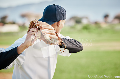 Image of Pitcher, back view or sports man in baseball stadium in a game on training field outdoors. Fitness, young softball athlete or focused man pitching or throwing a ball with glove in workout or exercise