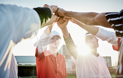 Image of Fist, motivation or sports men in huddle with support, hope or faith on baseball field in fun game together. Teamwork, hands up or group of excited softball athletes with goals, mission or solidarity