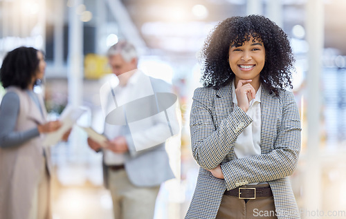 Image of Young business woman, portrait and smile of empowerment, motivation and confident project manager. Happy female employee standing in company for professional career, pride or happiness in busy office