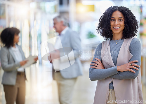 Image of Business, woman and portrait with arms crossed, smile and motivation of professional management. Happy young female employee standing in company for happiness, pride and confidence in busy startup