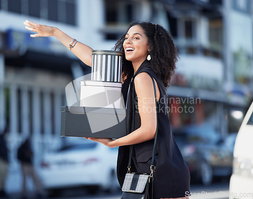 Image of Black woman, gift boxes and present box of a customer hail taxi outdoor in the city. Fashion sale, boutique and retail store promotion of a happy person done shopping and looking for transport