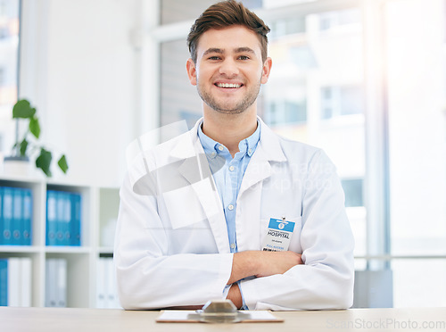 Image of Medical, smile and portrait of happy doctor in a hospital office feeling happy, excited and proud in a clinic. Young, medicine and man healthcare professional arms crossed satisfied with health