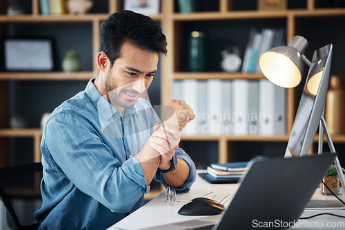 Image of Businessman working in the office with wrist pain, injury or accident medical emergency. Healthcare, professional and male employee sitting at his desk with sprain muscle in his hand in the workplace