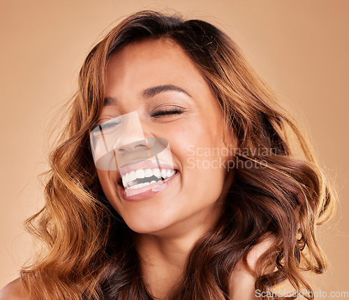 Image of Happy woman, hair care and face with beauty, laughing and cosmetics and balayage on studio background. Skincare, keratin treatment and cosmetology with eyes closed, makeup and female with smile