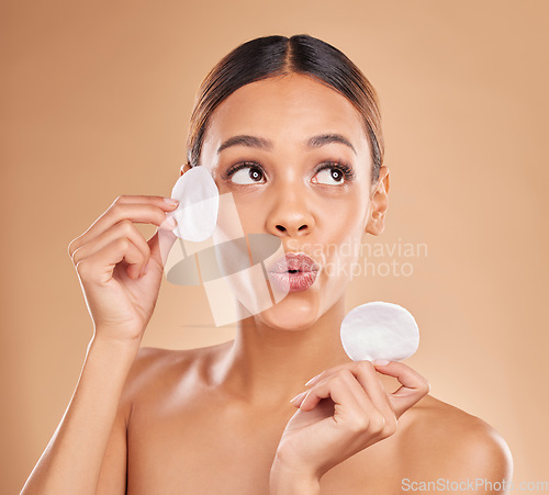 Image of Skincare, dermatology and woman with cotton pad, organic facial and treatment against a brown studio background. Female, lady and makeup remover with cosmetics, grooming and wellness with smooth skin