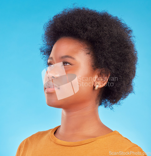 Image of Thinking, idea and black woman wondering looking away in thought isolated against a blue studio background. Afro, casual and face of young African American female relax, calm and confident