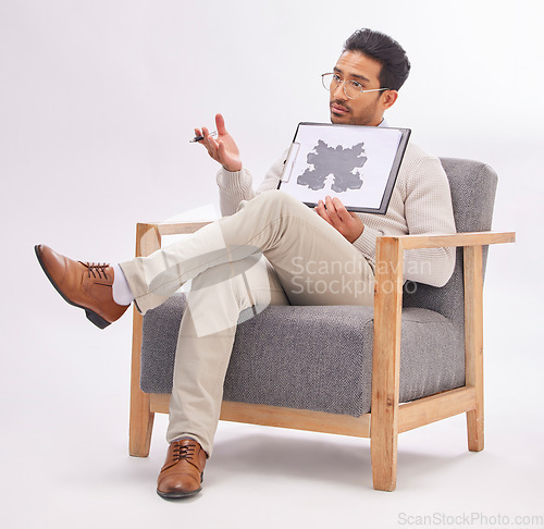 Image of Psychology, psychologist and man with rorschach test diagram on clipboard in studio isolated on a gray background. Therapist, consultant and male sitting on chair with document for inkblot exam.