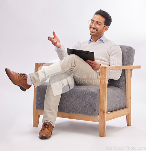 Image of Asian man, therapist and chair with clipboard in session isolated against a white studio background. Happy male psychologist or consultant in therapy, counseling or mental health solution on mockup