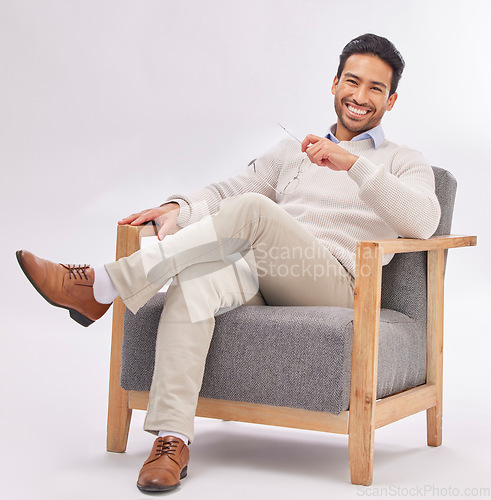 Image of Relax, chair and portrait of business man sitting happy with a smile and crossed legs isolated in studio white background. Gentleman, confident and professional or proud male employee or entrepreneur