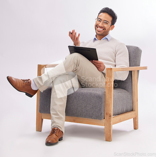 Image of Psychologist, doctor and mental health, man with smile in portrait and clipboard for medical checklist on studio background. Sitting on chair, therapy and happy male with advice, help and psychology