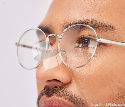 Image of Zoom, optometry and face of a man with glasses for vision, intelligence and eyecare. Looking, serious and guy wearing fashionable eyeglasses, showing frame and fit isolated on a studio background