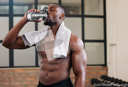 Image of Shirtless black man, gym and water bottle for health, break and energy of workout, training and exercise diet. Thirsty male, abs and drinking for fitness nutrition, body hydration and sports wellness