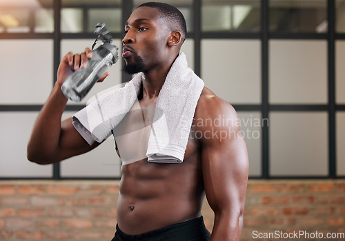 Image of Shirtless bodybuilder, black man and drinking water in gym for health, break and energy of workout, training or diet. Thirsty male, abs and bottle for fitness nutrition, hydration and sports wellness