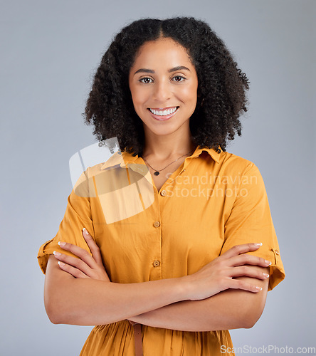 Image of Happy, pride and portrait of a woman with arms crossed isolated on a studio background. Smile, proud and headshot of a corporate employee with confidence, success and happiness on a backdrop