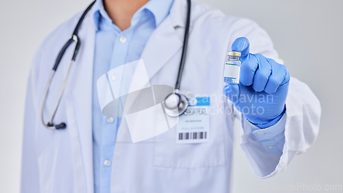 Image of Vaccine vial, doctor and hands in studio for safety, healthcare and pharmaceutical medicine. Closeup, vaccination and bottle for virus immunity, medical antibiotics and wellness drugs on background