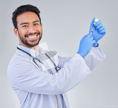 Image of Covid, vaccine and portrait of doctor in studio, happy and smile for medicine, breakthrough or cure on grey background. Medical, innovation and face of male corona expert with futuristic treatment