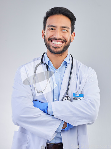 Image of Doctor, man and portrait in a studio with a smile from success, motivation and stethoscope. Happiness, medical consultant and hospital worker with white background smiling about health and wellness