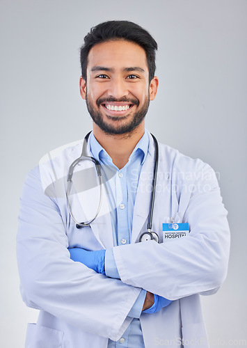 Image of Doctor, happy man and portrait in a studio with a smile from success, motivation and stethoscope. Happiness, medical consultant and hospital worker with gray background smiling about health vision