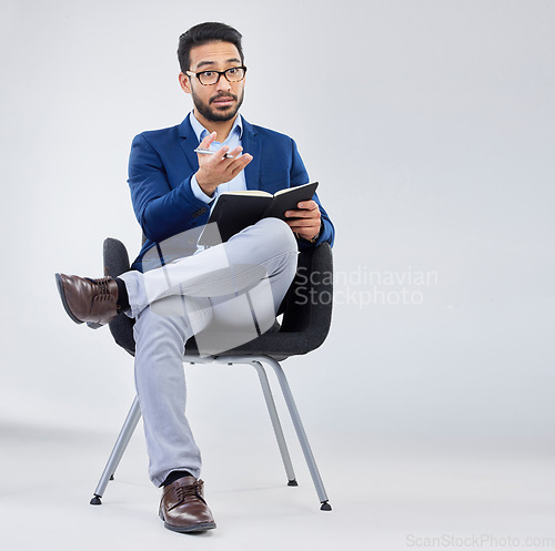 Image of Questions, human resources and businessman with notebook for interview process in studio on grey background. Recruiter, asian male and recruitment process, negotiation and onboarding discussion