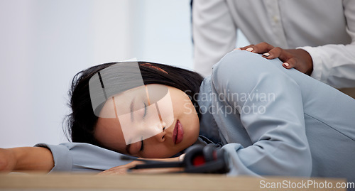 Image of Sleeping, tired and employee with burnout on an office table feeling overworked and sleep on her desk. Nap, dreaming and female businesswoman napping and exhausted due to fatigue at workplace