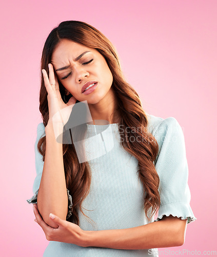 Image of Stress, depression and woman with headache in studio, tired and exhausted isolated on pink background. Mental health, burnout and depressed hispanic model with hand on head in pain and temple massage
