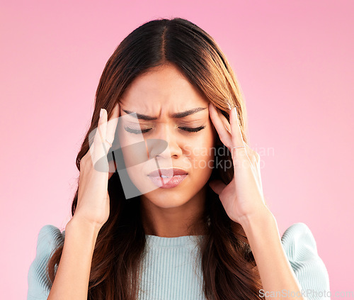 Image of Stress, anxiety and depression, woman with headache in studio, tired and exhausted on pink background. Mental health, burnout and depressed hispanic model with hand on head in pain and temple massage