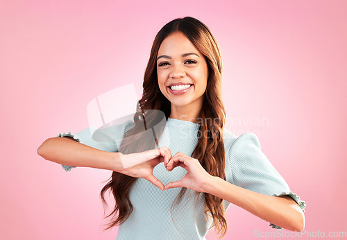 Image of Love, heart hands and portrait of woman in studio for romance, positive and kindness. Peace, support and emoji with female and shape isolated on pink background for emotion, hope and happy gesture