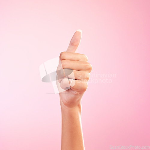 Image of Thumbs up, yes and hand of woman in studio for success, approval, achievement and support. Like, emoji and thank you with female and gesture isolated on pink background for positive, agreement and ok