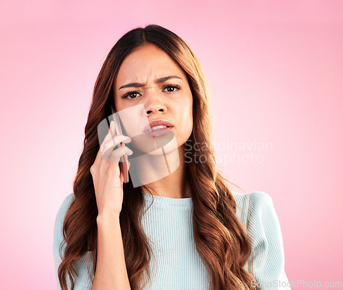 Image of Annoyed, phone call and portrait of woman in studio for confused, communication and bad news. Problem, conflict and frustrated with female isolated on pink background for negative, upset and contact