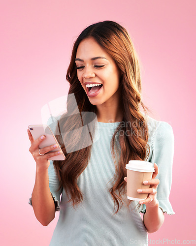 Image of Phone, coffee and woman laughing in studio isolated on a pink background. Tea, cellphone and happy mixed race female with smartphone for social media, funny meme or comic joke, web browsing and text.