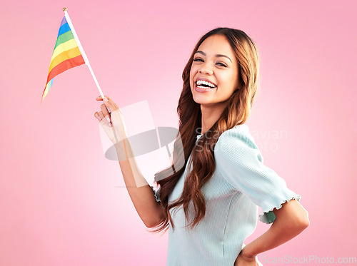 Image of LGBT, pride portrait or happy woman with rainbow flag for self love, individuality or LGBTQ community support. Equality, human rights girl or studio bisexual, gay or lesbian person on pink background