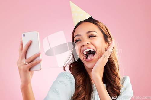 Image of Birthday, selfie and excited with a woman in studio on a pink background for the celebration of an event. Phone, social media and party with an attractive young female celebrating a special occasion