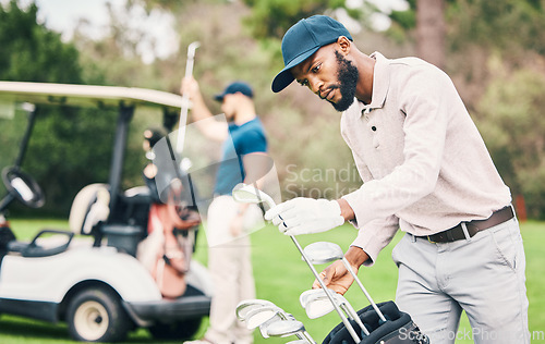 Image of Golf, club and black man choose on course with golfing bag ready to start game, practice and training. Professional golfer, activity and male caddy with choice for exercise, fitness and recreation