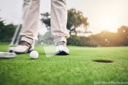 Image of Golf, hole and legs of athlete or player hit ball and professional golfer training and putting on a filed as exercise or workout. Feet, equipment and gentleman or person relax and playing a sport